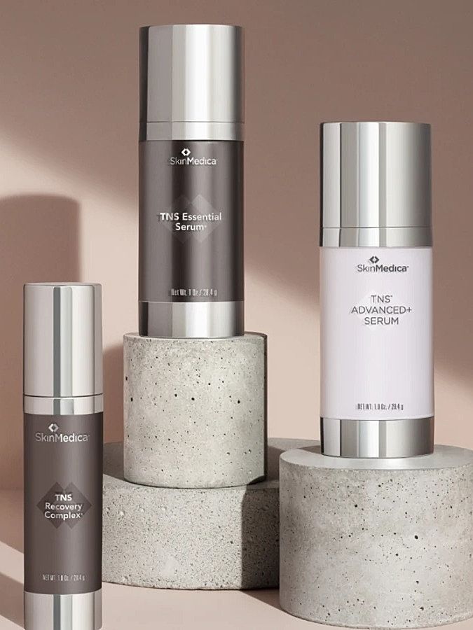 Skincare cream jars with water droplet background.