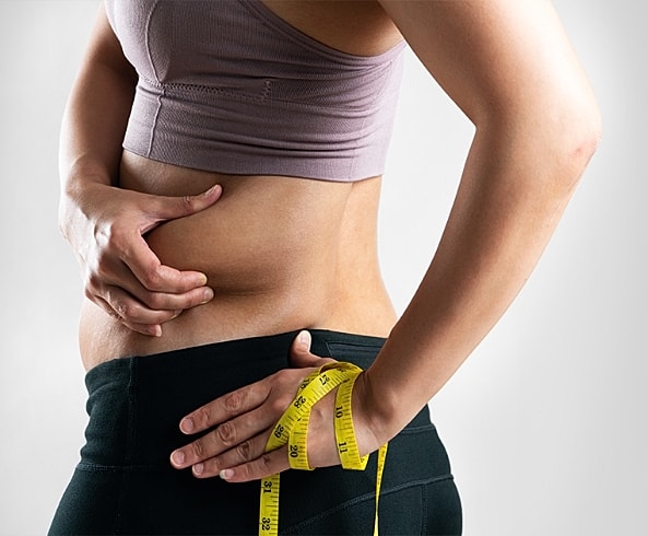 Measuring waist size with tape measure.