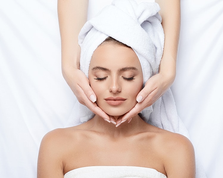 Woman receiving a relaxing facial treatment.
