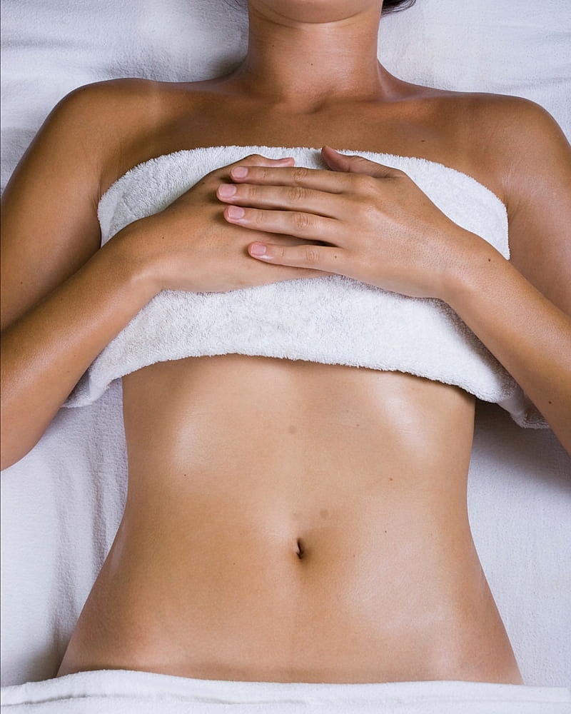 Spa treatment with a woman relaxing on a massage table.