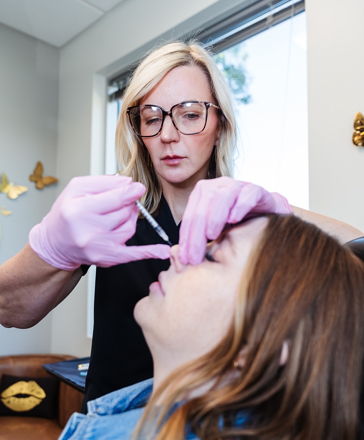 Professional administering cosmetic injection treatment.