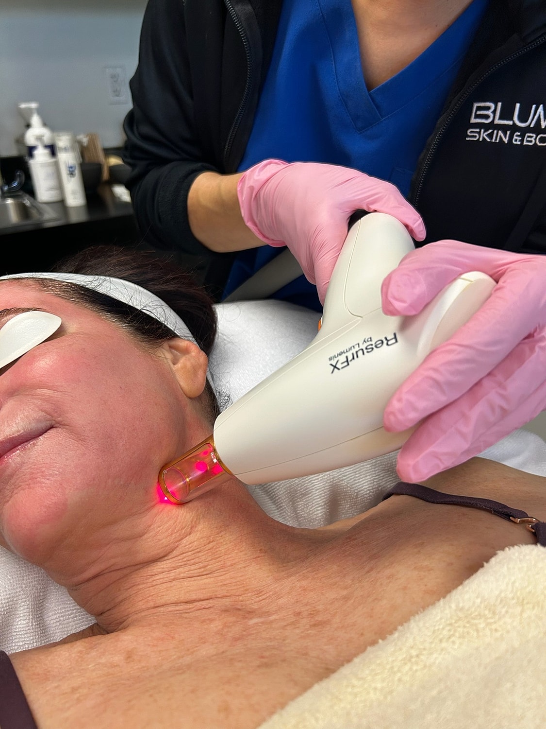 Laser treatment on a woman's neck in clinic.