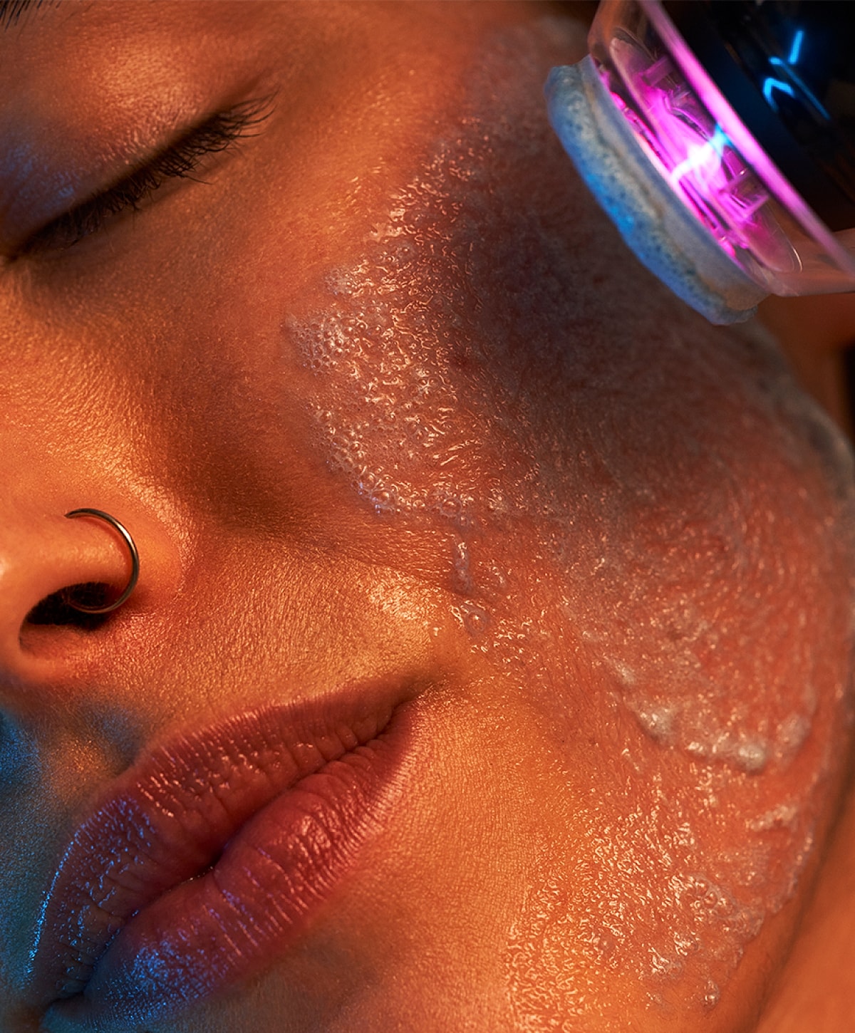 Facial treatment with cleansing device on skin.