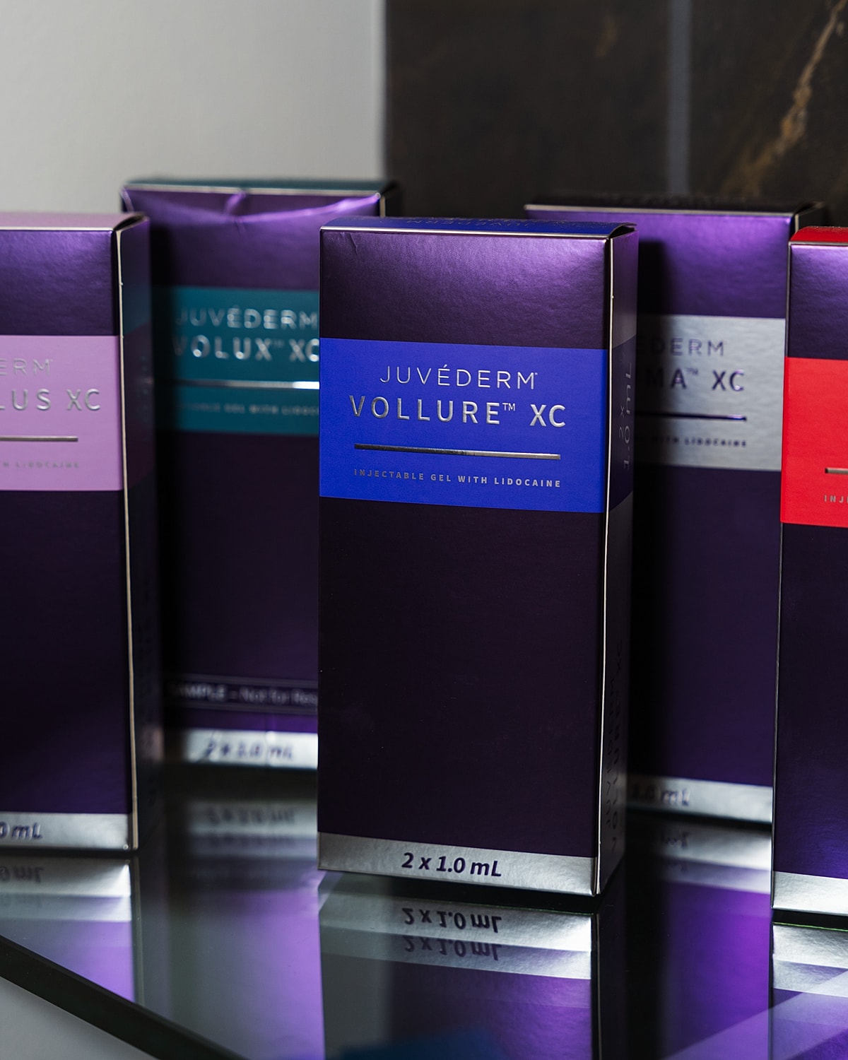 Juvéderm injectable gel packaging on mirror surface.
