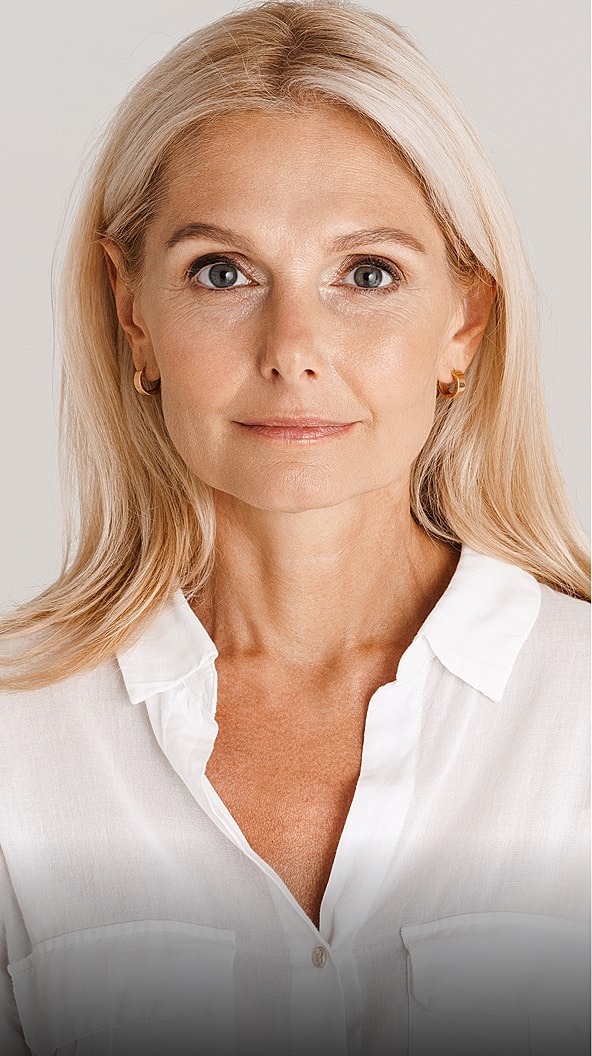 Mature woman with light blonde hair, neutral expression.