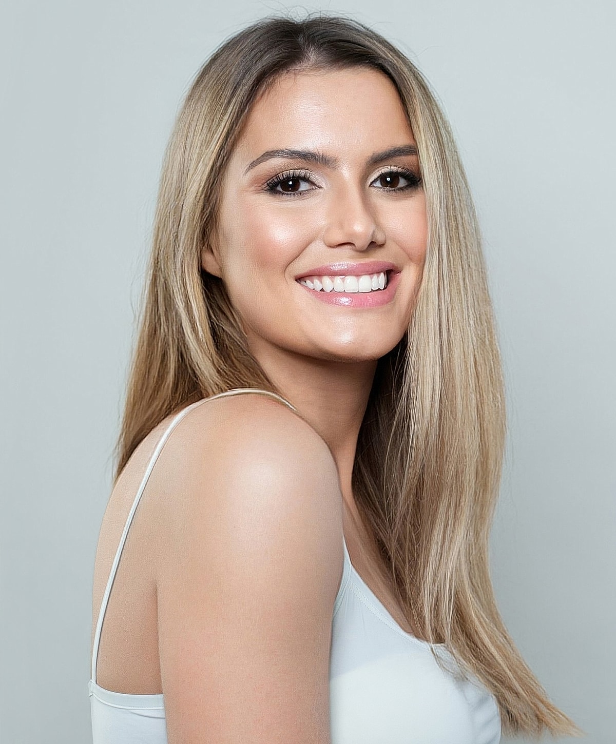 Smiling woman with long, straight blonde hair.