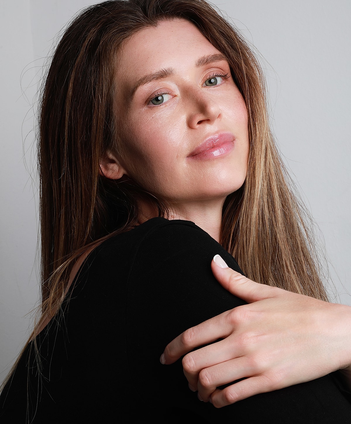 Woman with long hair smiling softly.