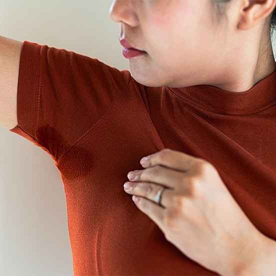 Woman checking for underarm sweat stains.