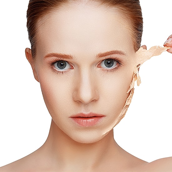 Woman removing facial mask, skin care routine.
