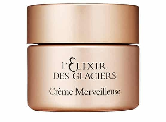 Luxury skincare jar with golden packaging.