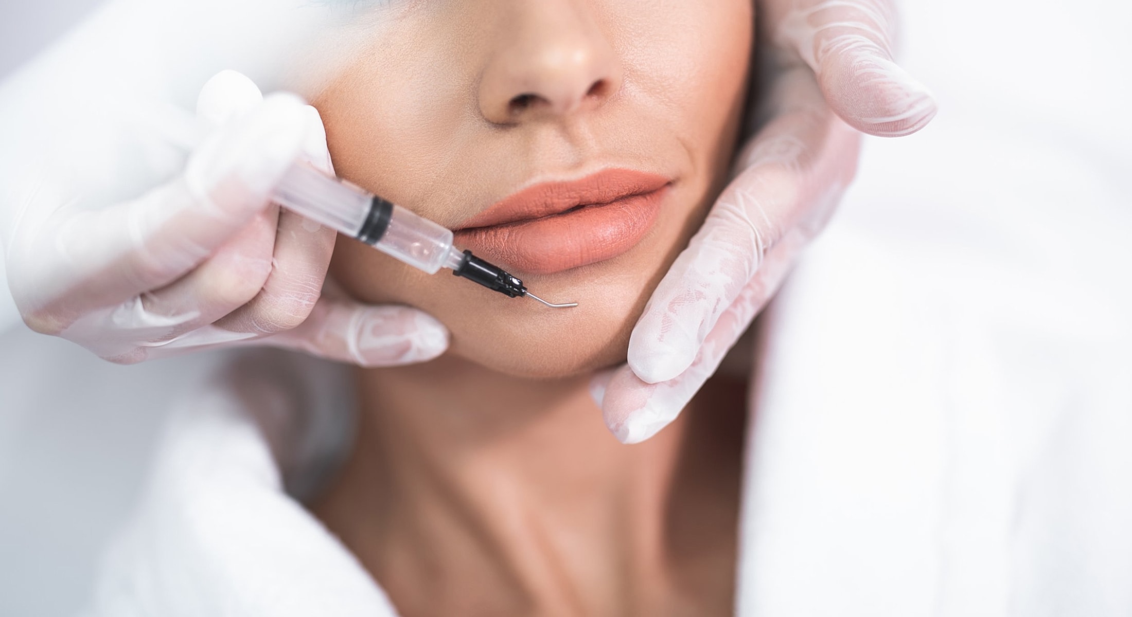 Cosmetic procedure involving injection near the lips.