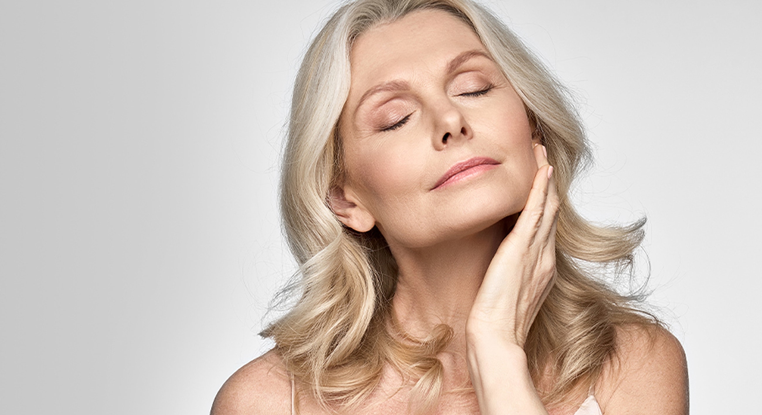 Woman receiving a facial treatment in clinic.