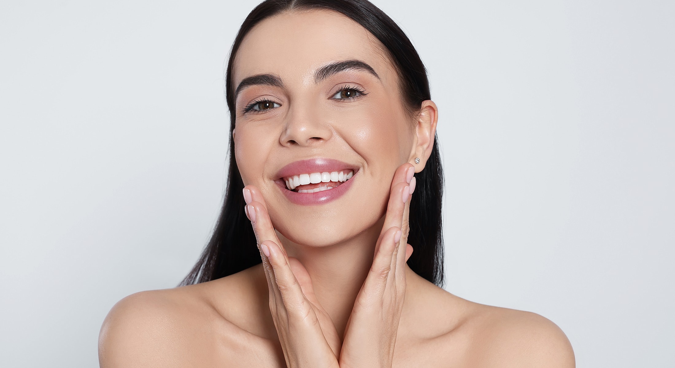 Smiling woman showcasing radiant skin and confidence