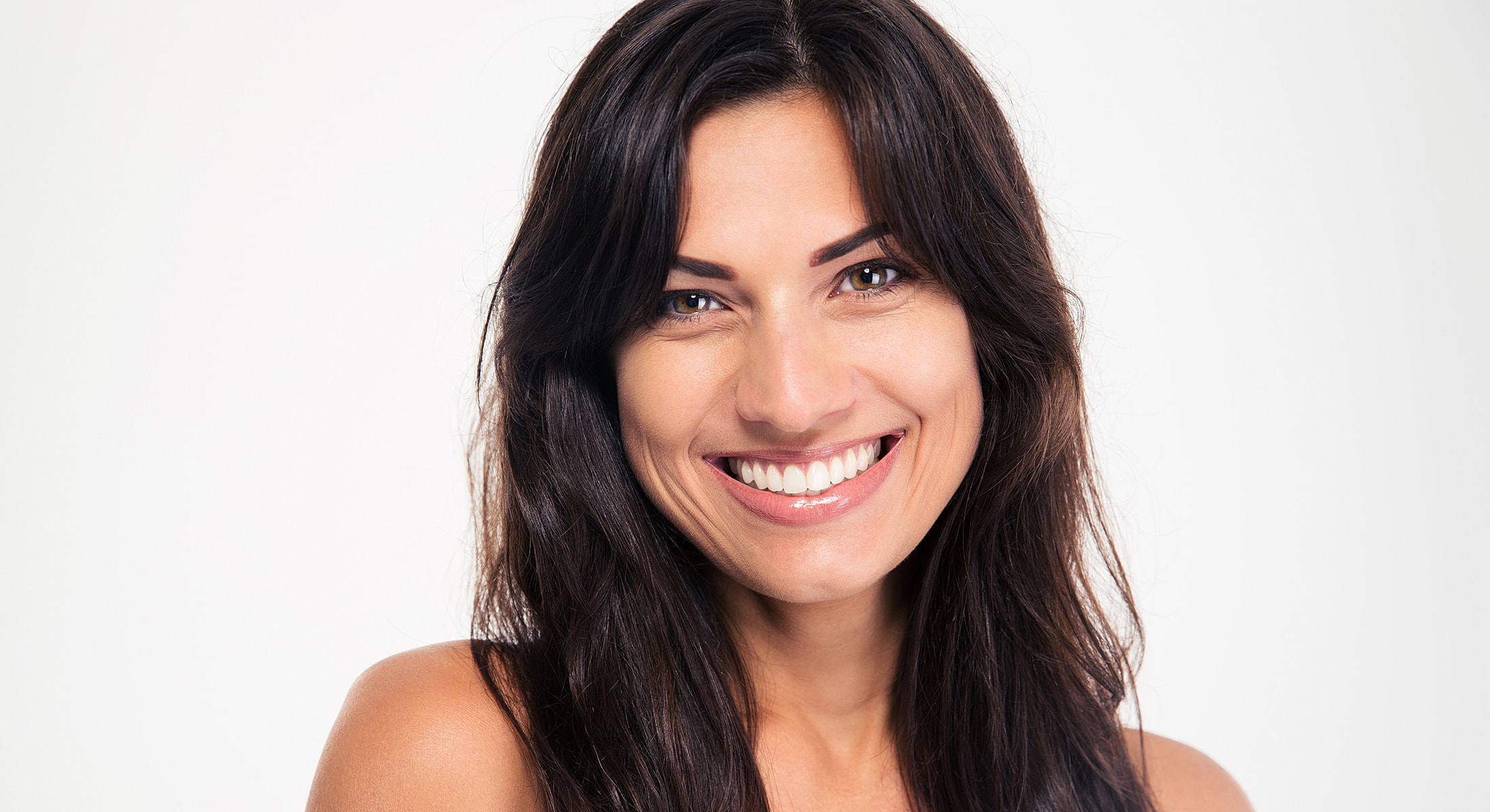 Smiling woman with long, dark hair against white background.