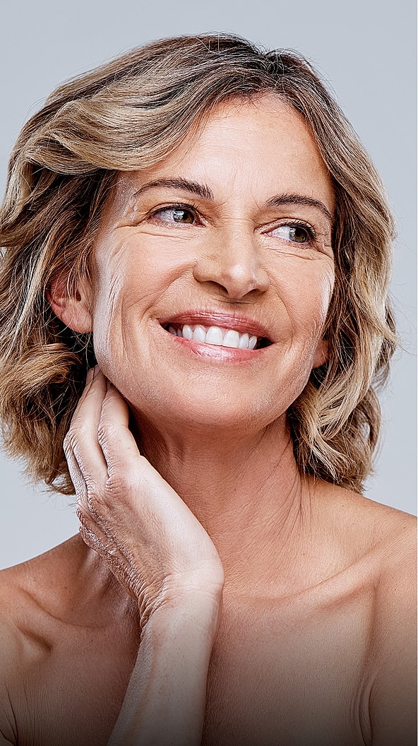 Smiling Scottsdale med spa woman with wavy hair and natural beauty.