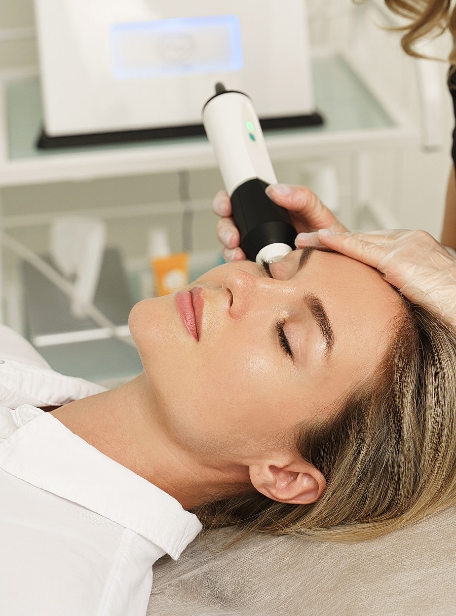 Scottsdale med spa woman receiving facial treatment in spa setting.